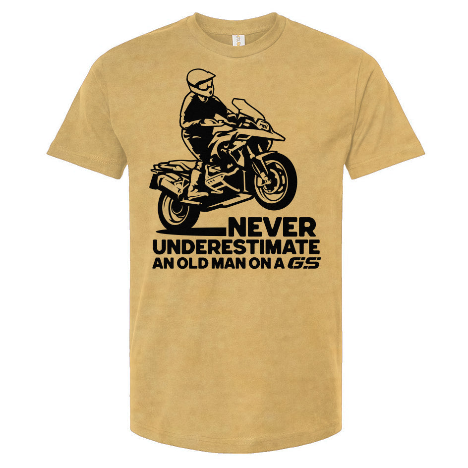 T-shirt with a man wheelie on a GS motorcycle sitting proudly with text below saying "never underestimate an old man on a gs"