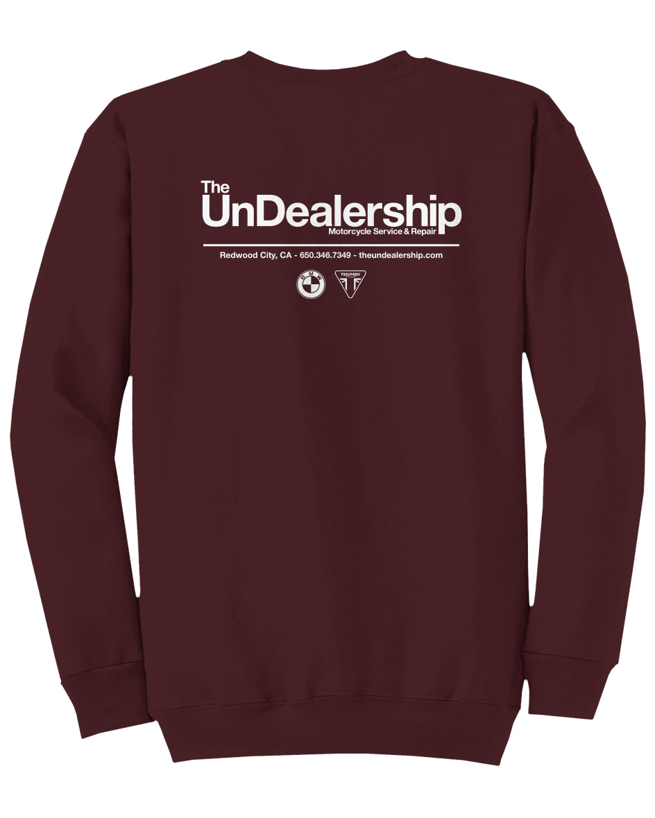 Maroon sweatshirt with 'The UnDealership' text on the back against a white background