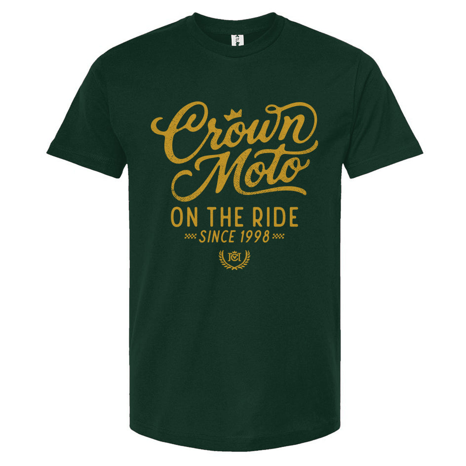 Forest Green short-sleeve t-shirt with a gold graphic print on the front reading 'Crown Moto ON THE RIDE SINCE 1998' on a plain white background.