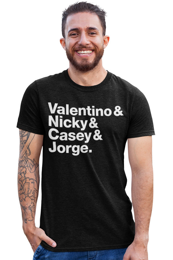 man wearing a black t-shirt with MotoGP champion names on chest in white