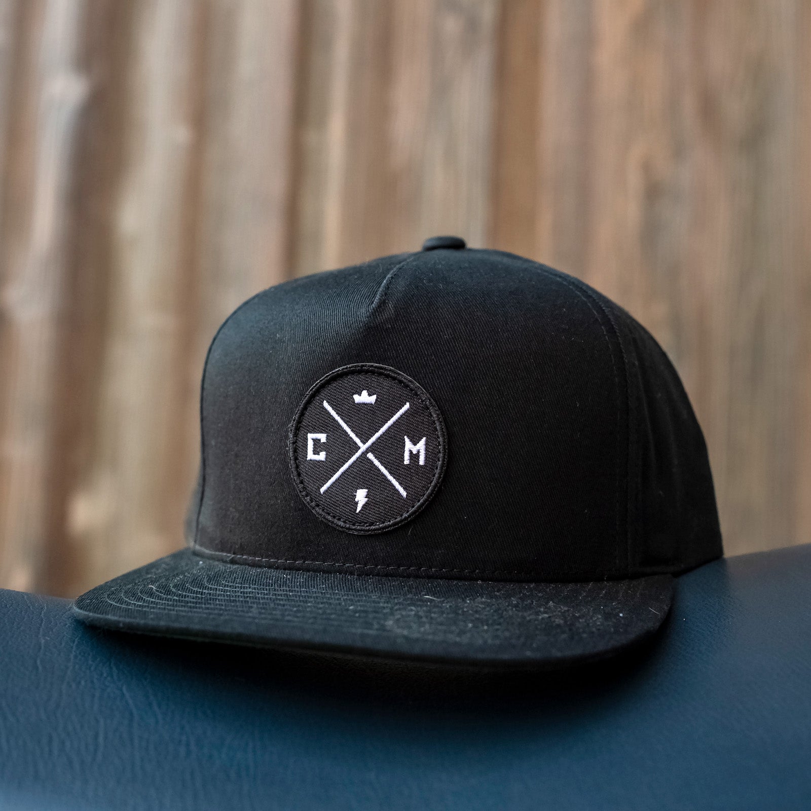 crown moto legend patch on front of black cotton yupoong snapback hat, motorcycle lifestyle brand, flat brim, premium quality hat, hats for motorcyclists
