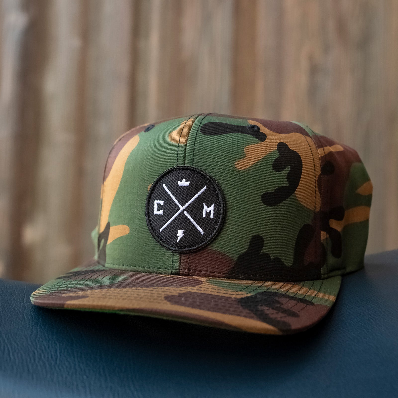 crown moto legend patch on front of green camouflage yupoong snapback hat, motorcycle lifestyle brand, flat brim, premium quality hat, hats for motorcyclists