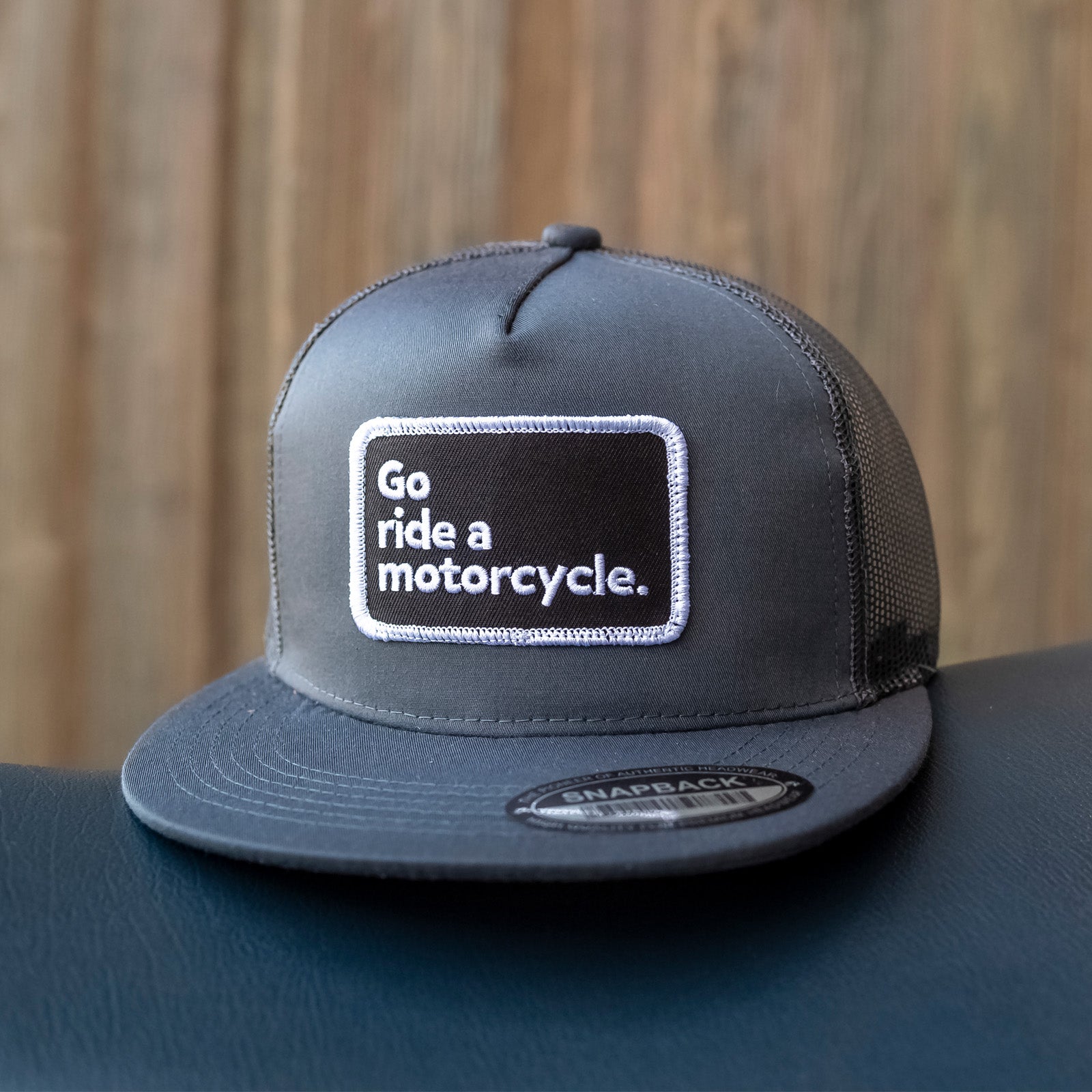 "Go ride a motorcycle" charcoal grey Snapback Trucker Hat, original patch, nickel crown moto rivet on back