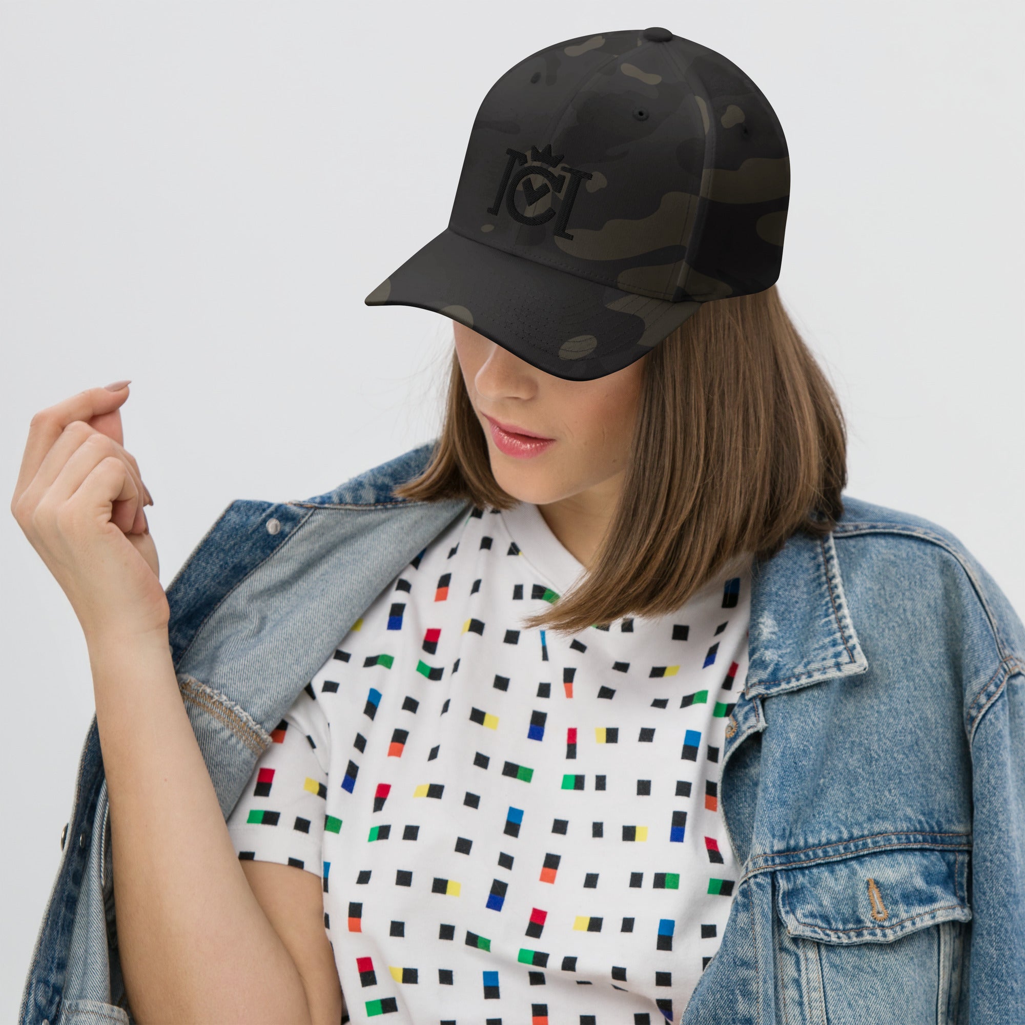 Woman wearing Trademarked crown moto logo embroidered in 3D puff style on front of flexfit hat