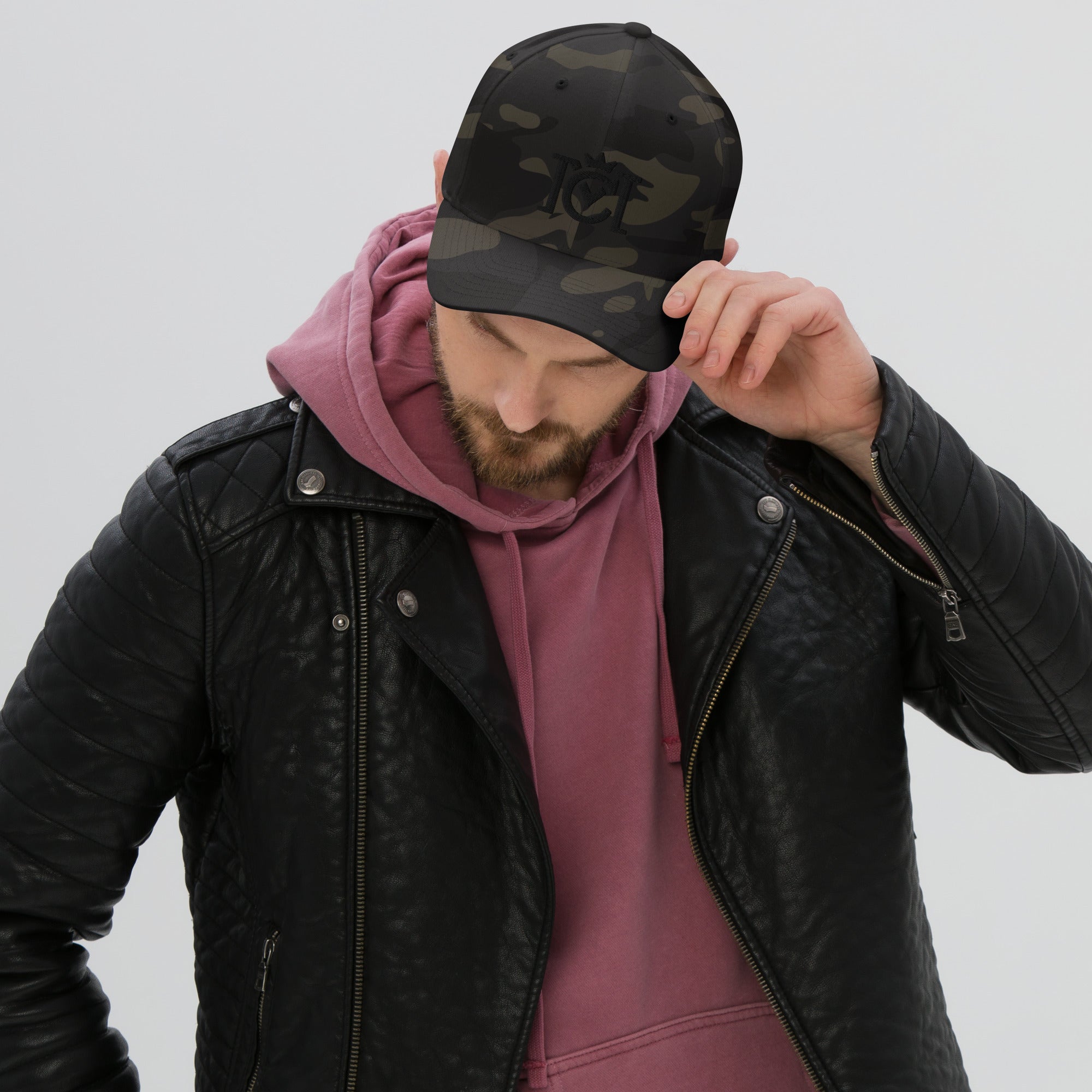 Man wearing Trademarked crown moto logo embroidered in 3D puff style on front of flexfit hat
