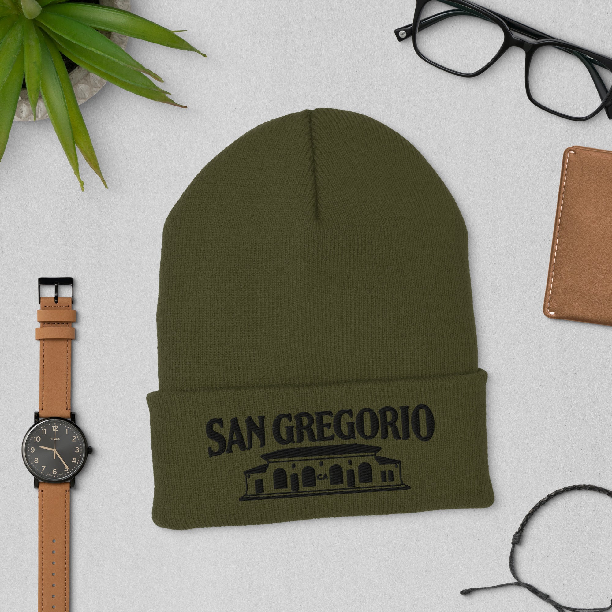 olive green beanie with San Gregorio General Store design embroidered on cuff