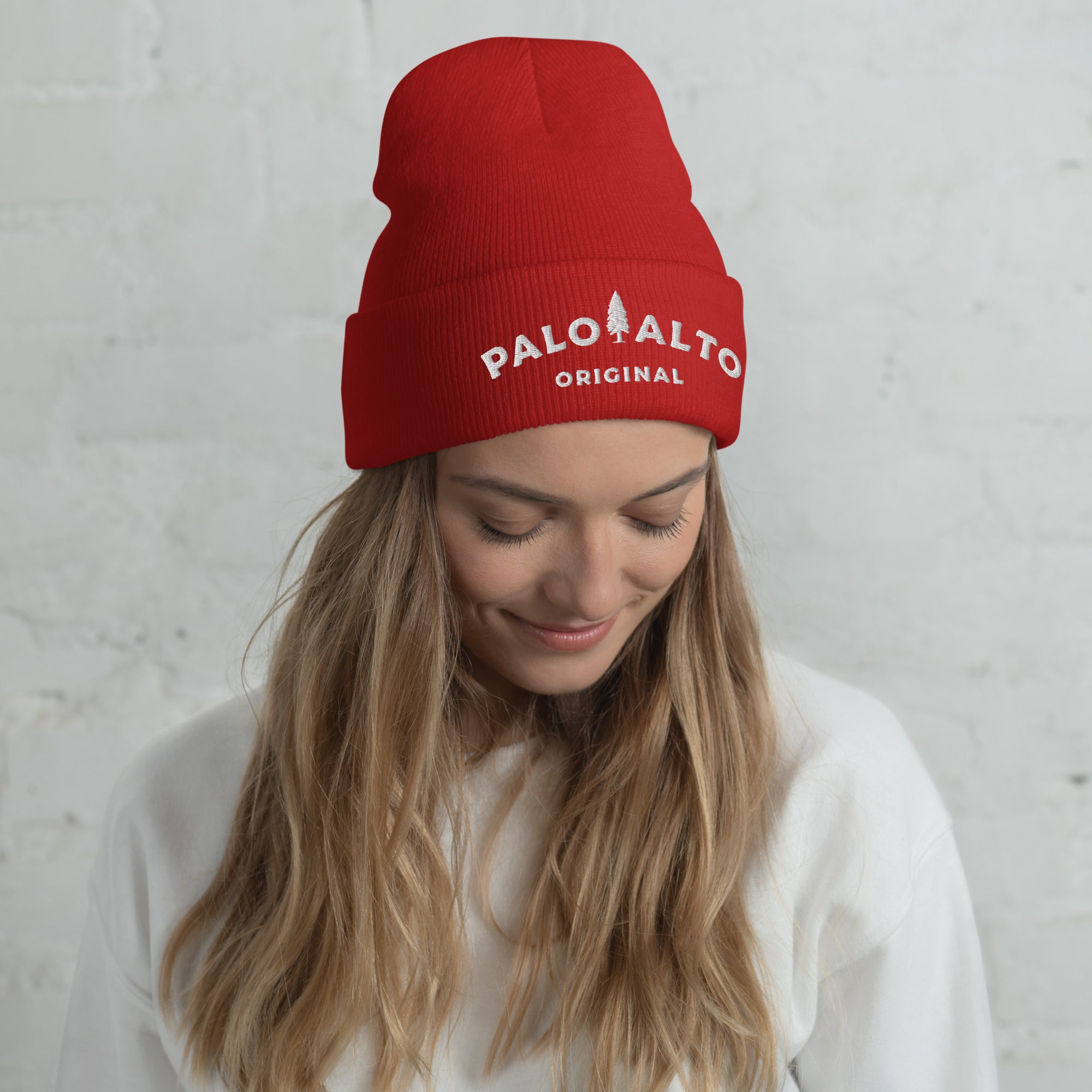 Woman wearing red Palo Alto Original fine ribbed knit beanie