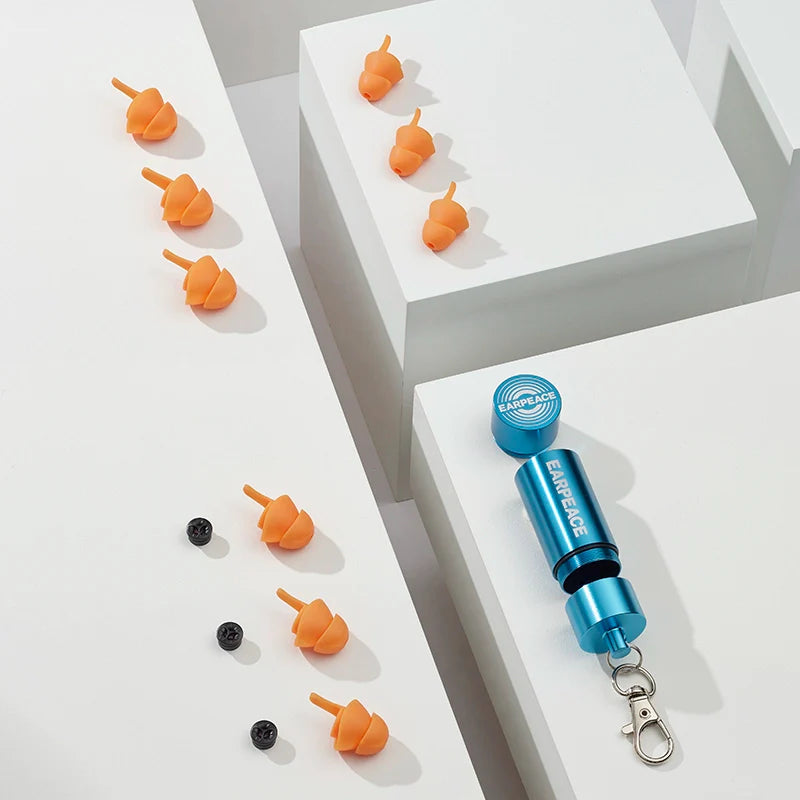 Blue and silver device with orange attachments on a white surface
