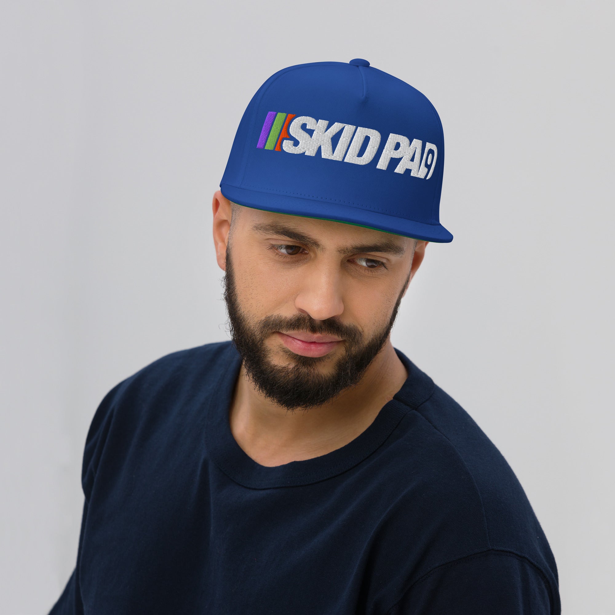 Man wearing Skid Pad 9 embroidered hat