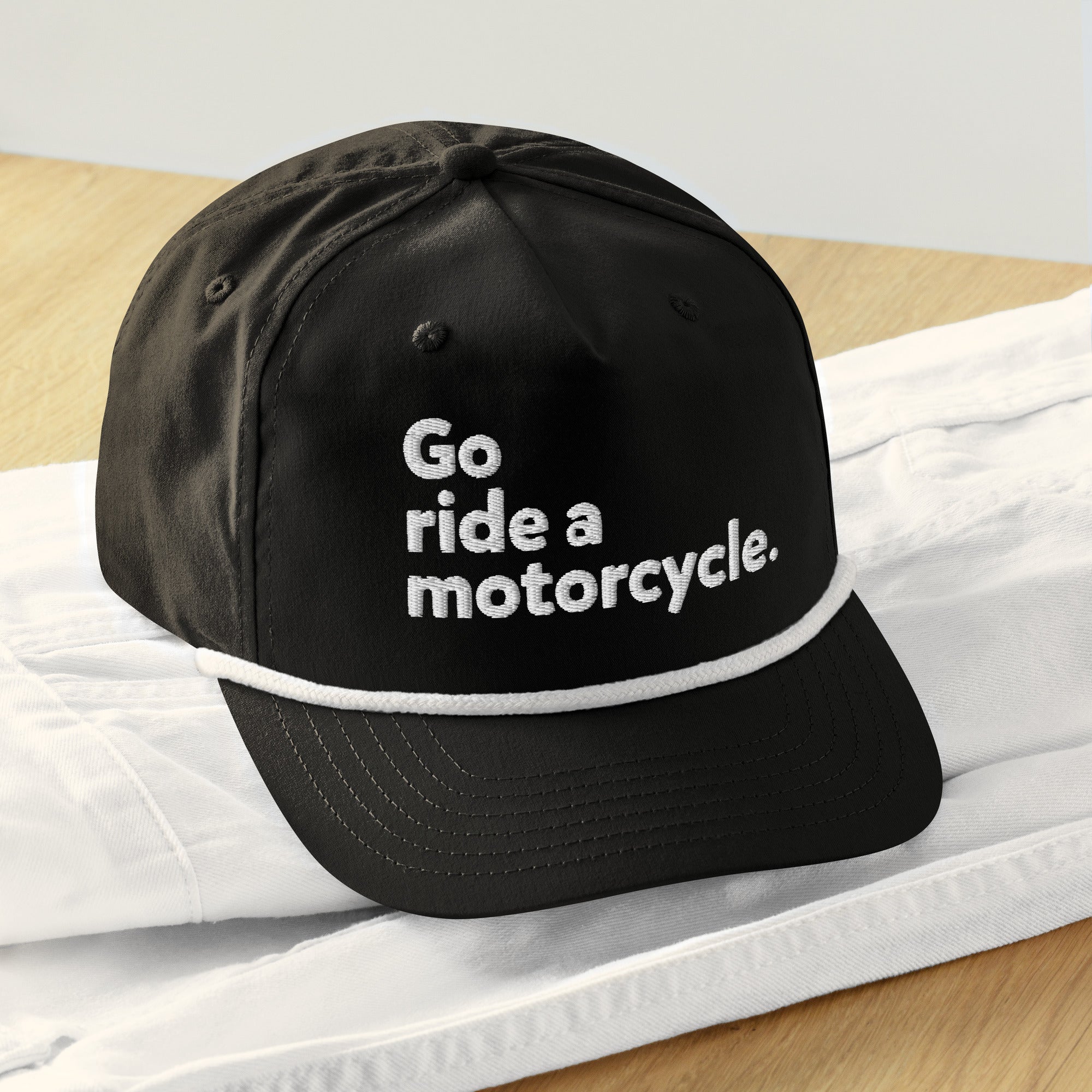 Go ride a motorcycle embroidered golf rope cap sitting on a table, b&w, snapback, adjustable, gifts for riders, gifts for motorcyclists