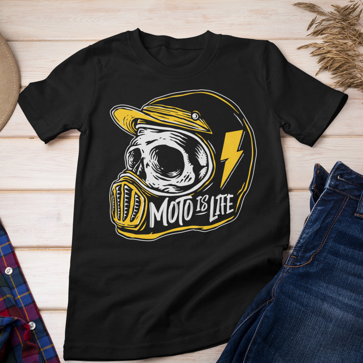 Moto is Life black t-shirt displayed on a table with other clothing items