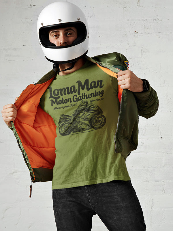 man wearing motorcycle helmet opening his jacket to show green t-shirt with "Loma Mar Motor Gathering" "slow your roll" moto sketch design on chest in black