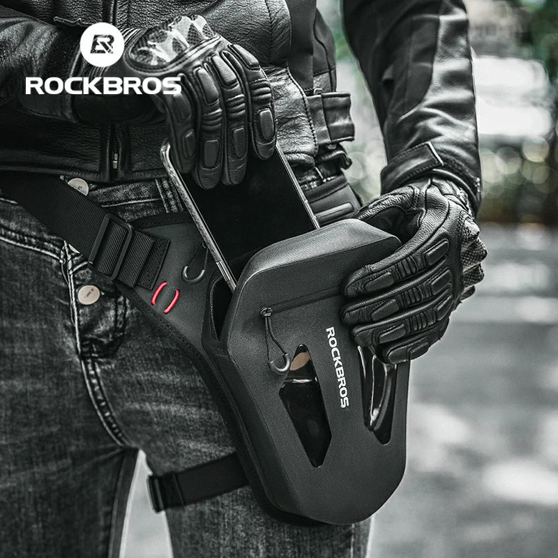 Person holding a black tool with 'RockBros' branding, wearing gloves and a leather jacket.