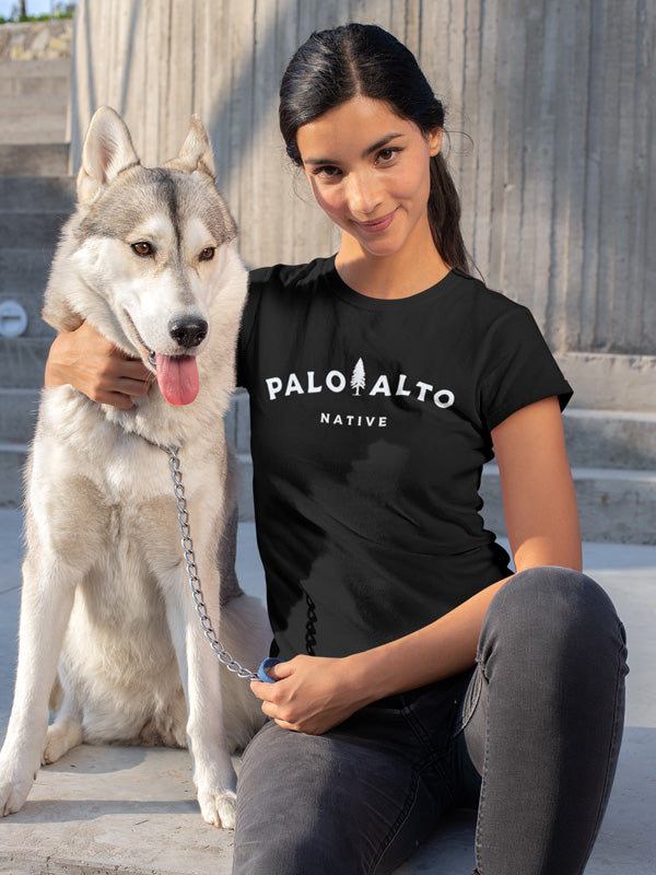 Beautiful female model wearing a black Palo Alto Native women's t-shirt by Crown Moto with her husky dog