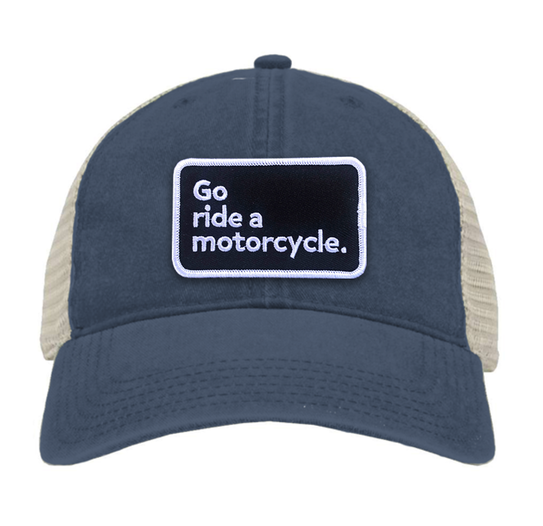 "Go ride a motorcycle" pigment dyed navy trucker hat with patch sewn on front