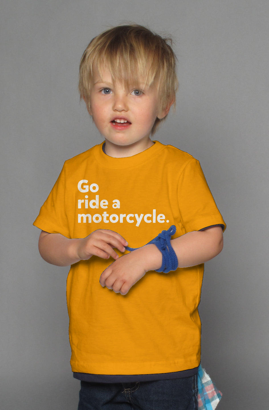 "Go ride a motorcycle" design printed in white on chest of kid's short sleeve t-shirt