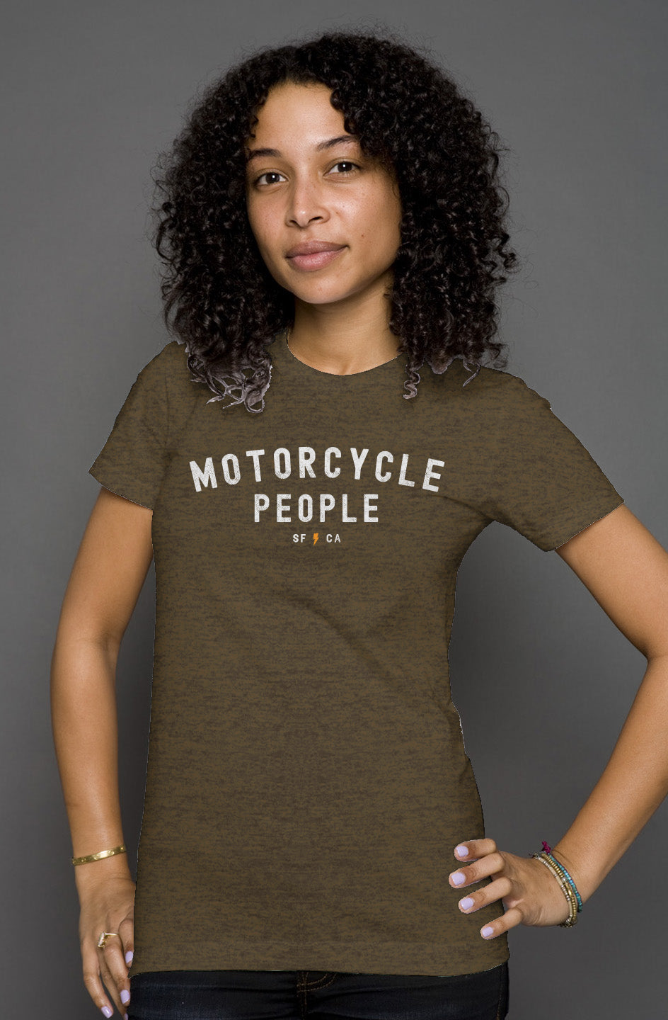 Attractive woman wearing heather short sleeve t-shirt with "motorcycle people" SF CA design on chest