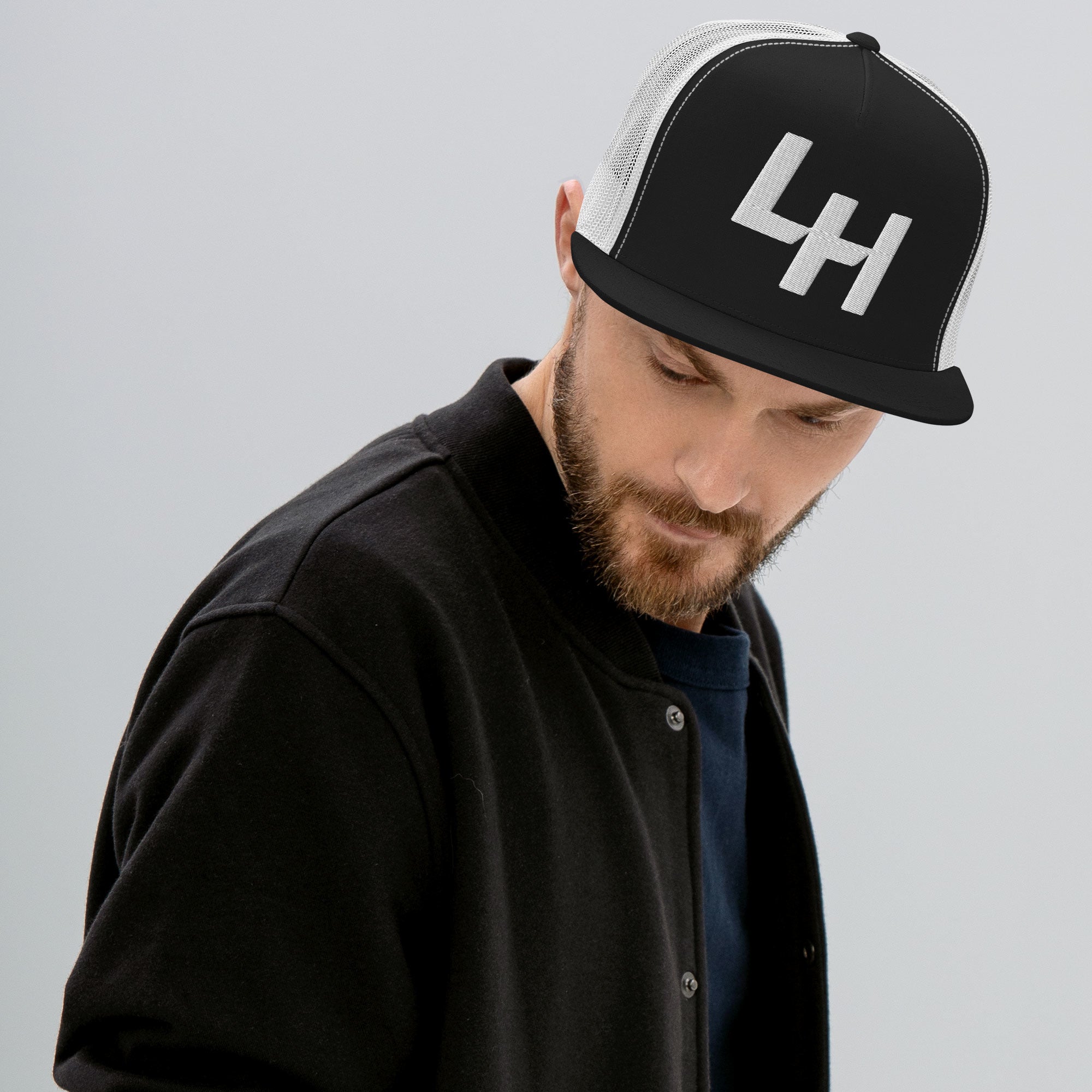 Man wearing Trucker hat with La Honda california LH shift pattern design embroidered on front