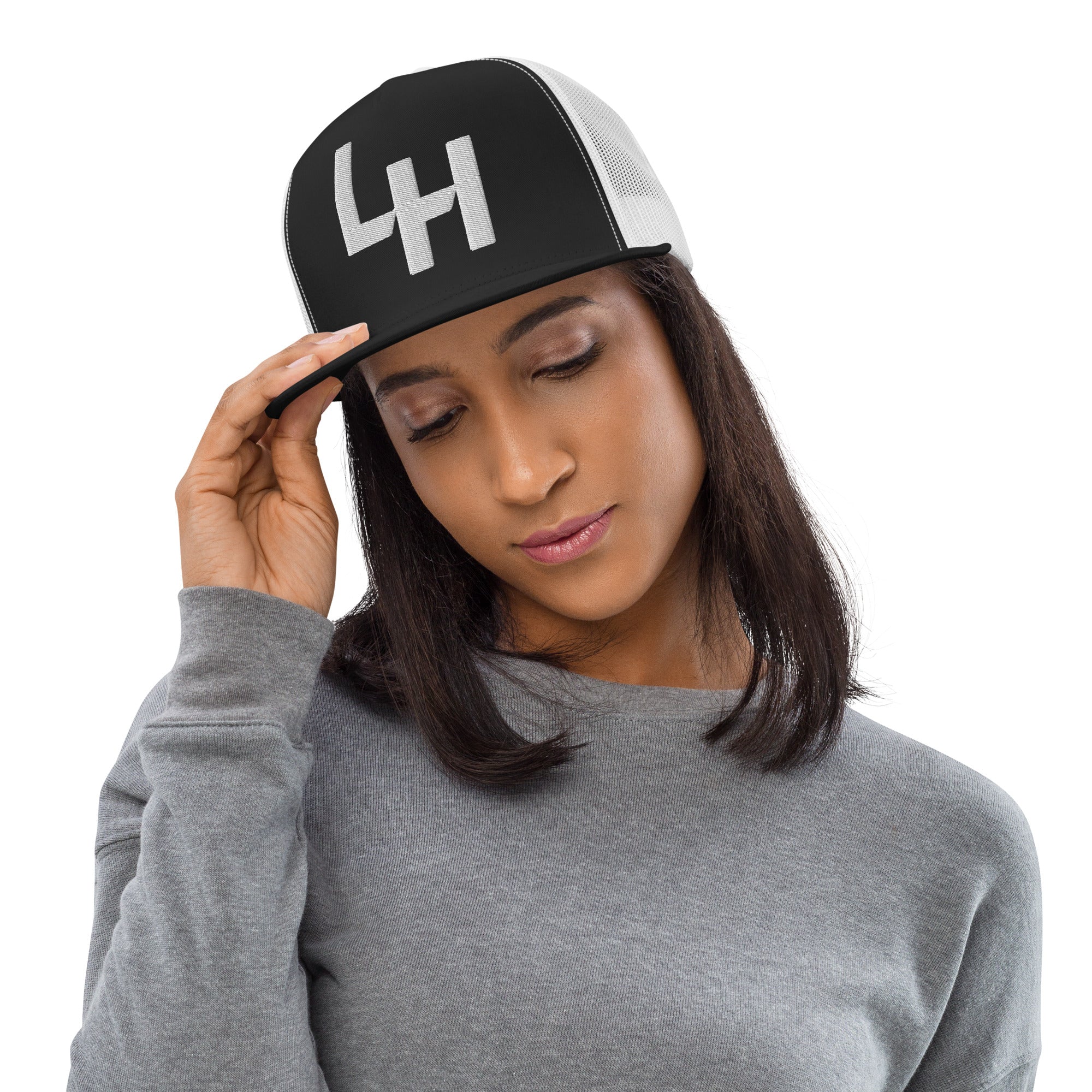 Woman wearing Trucker hat with La Honda california LH shift pattern design embroidered on front