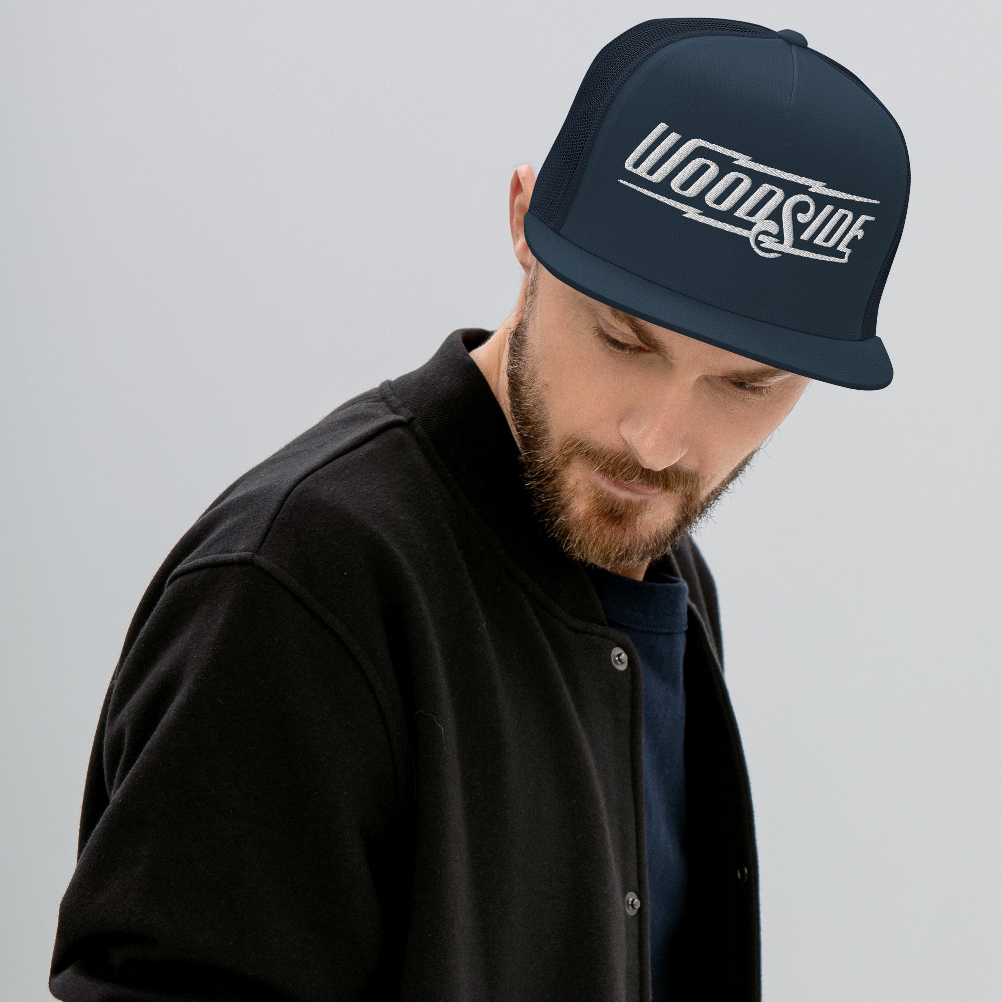 Man wearing Woodside Brand embroidered snapback trucker hat with white embroidery