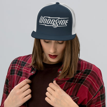 Woman wearing Woodside Brand embroidered snapback trucker hat with white embroidery