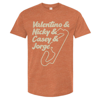 A crewneck t-shirt with text and a graphic design in a cream color. The text lists 'Valentino & Nicky & Casey & Jorge' with a stylized representation of a motorcycle track beneath it.
