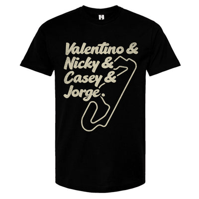 A navy blue crewneck t-shirt with text and a graphic design in a cream color. The text lists 'Valentino & Nicky & Casey & Jorge' with a stylized representation of a motorcycle track beneath it.
