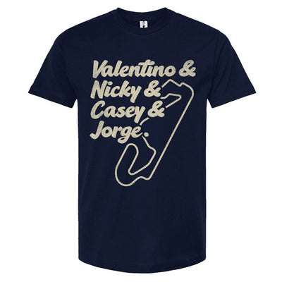 A navy blue crewneck t-shirt with text and a graphic design in a cream color. The text lists 'Valentino & Nicky & Casey & Jorge' with a stylized representation of a motorcycle track beneath it.