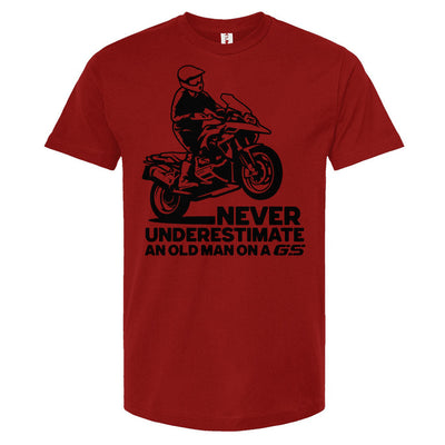 T-shirt with a man wheelie on a GS motorcycle sitting proudly with text below saying "never underestimate an old man on a gs"