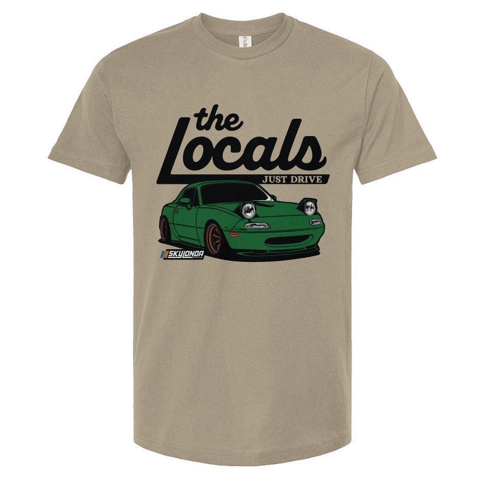 Sand colored t-shirt with a graphic of a green Mazda Miata and 'the Locals' text on a white background