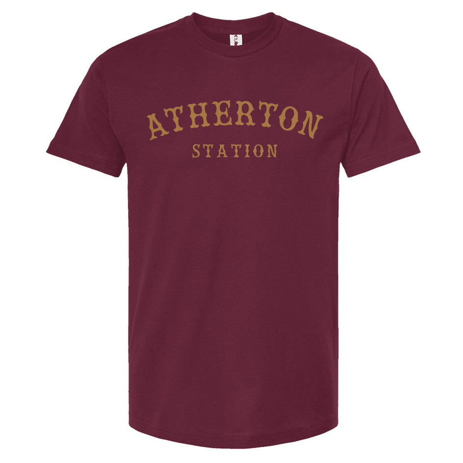 Burgundy t-shirt with gold 'Atherton Station' text across the chest