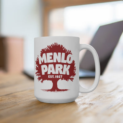 White mug with red 'Menlo Park Est. 1927' design on a wooden surface.