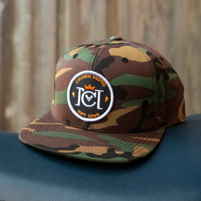 crown moto og logo patch on front of green camouflage yupoong snapback hat, motorcycle lifestyle brand, flat brim, premium quality hat, hats for motorcyclists, logo, motorbikes, motorcycles