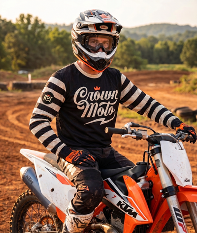 Motocross rider sitting on a KTM dirt bike wearing a crown moto 98 riders club mx jersey
