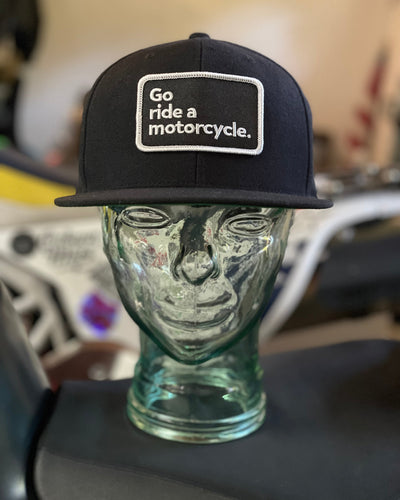 "Go ride a motorcycle" black snapback flat brim hat from Crown Moto