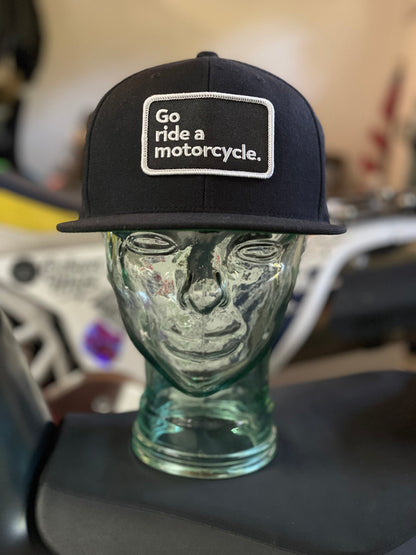 "Go ride a motorcycle" black snapback flat brim hat from Crown Moto