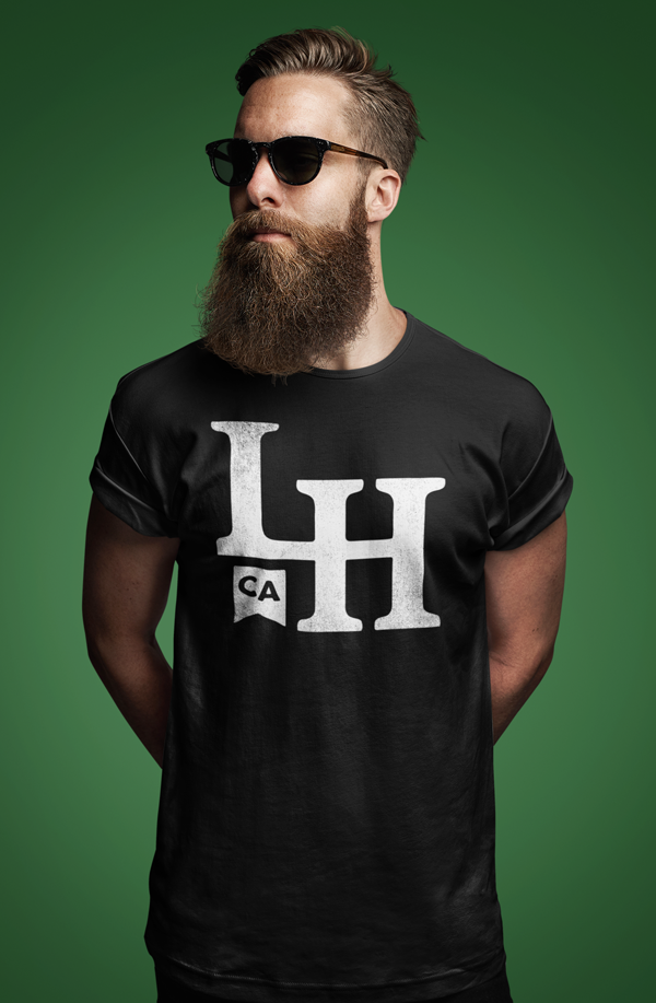 Bearded man wearing black t-shirt with La Honda LH monogram design on chest