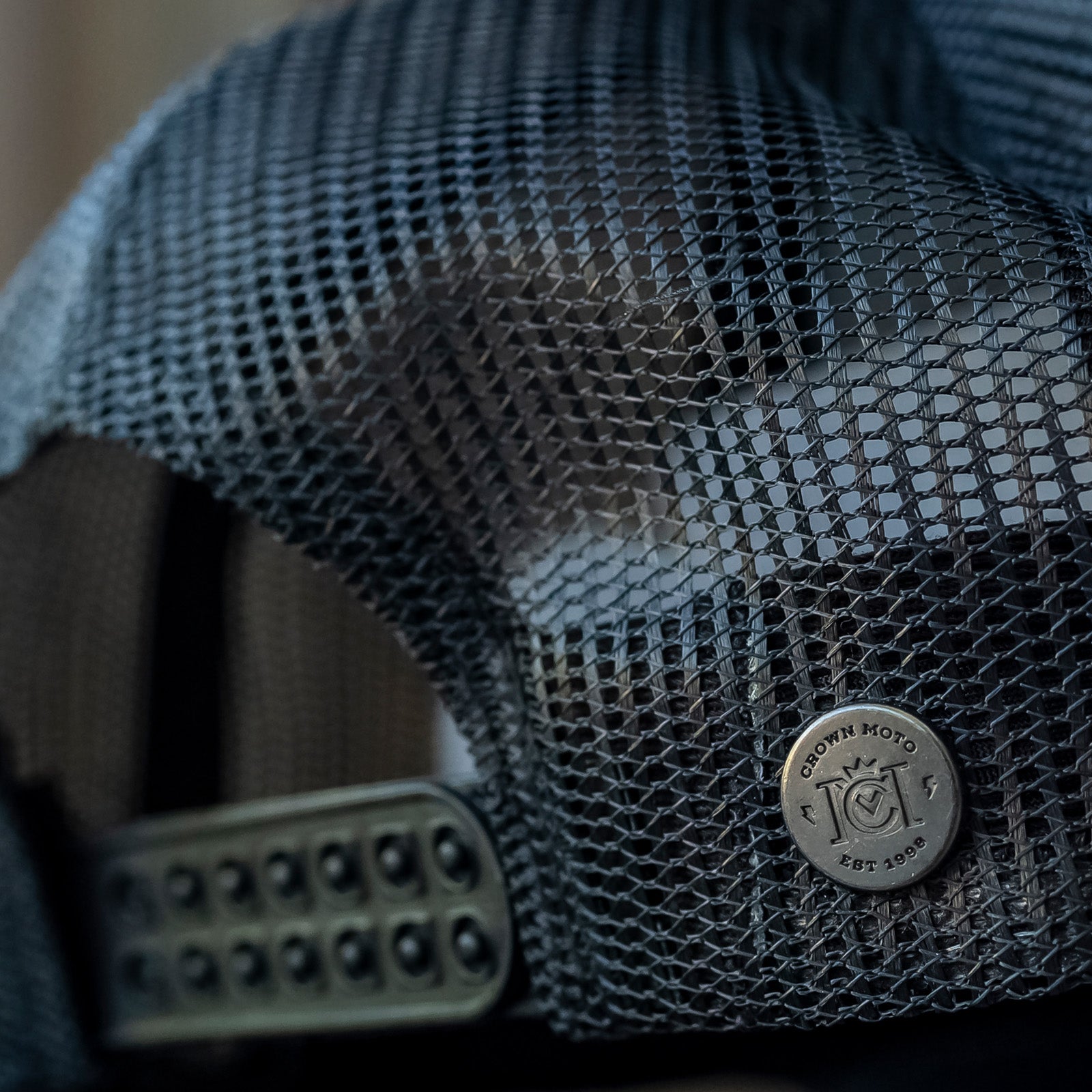 Go ride a motorcycle charcoal gray and black snapback trucker hat with crown moto branded nickel rivet on back and double snapback closure