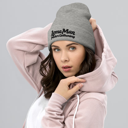 Woman wearing grey knit beanie with "Loma Mar Motor Gathering" embroidered on cuff of beanie