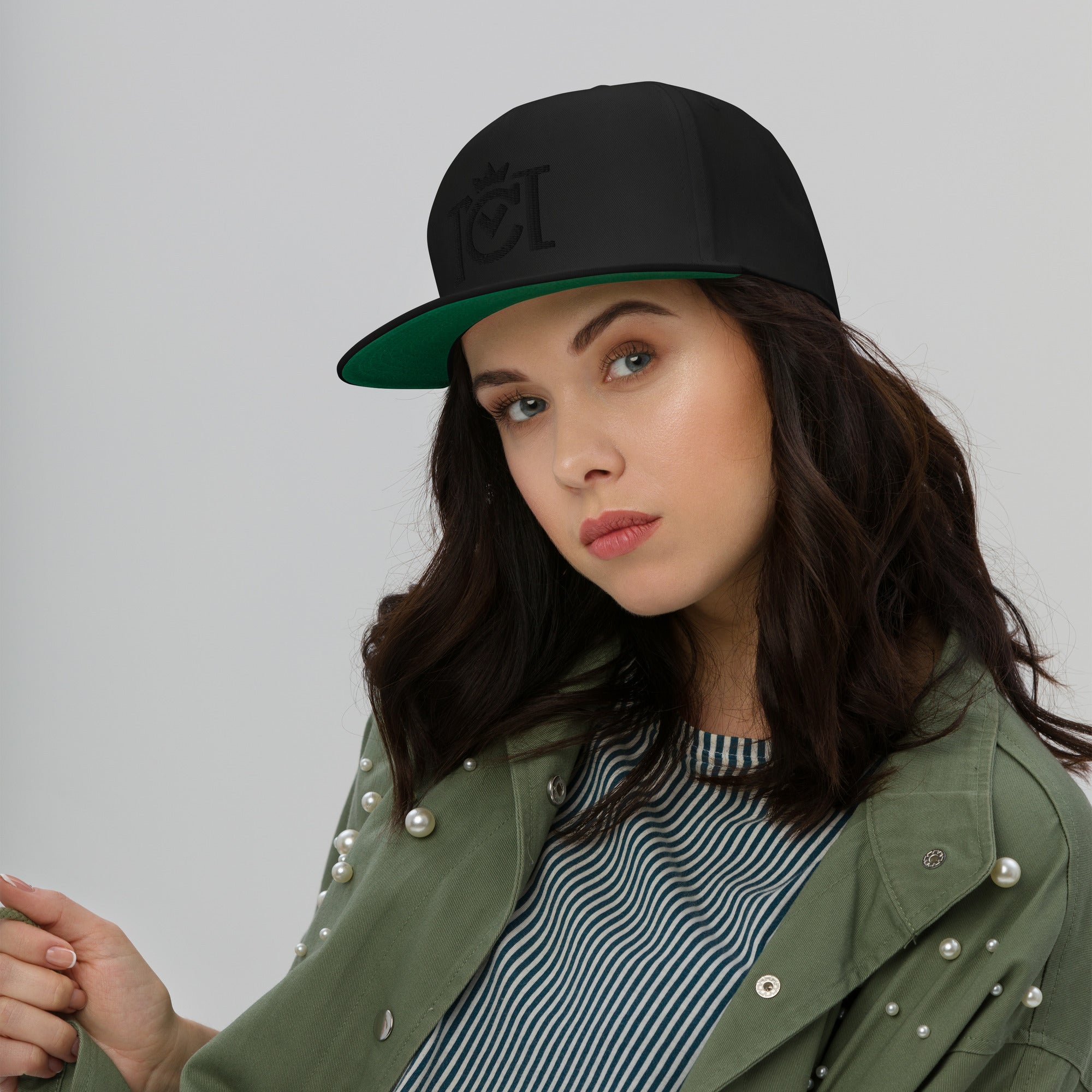 Woman wearing Trademarked Crown Moto logo embroidered in black 3D puff style on front of flat bill snapback hat