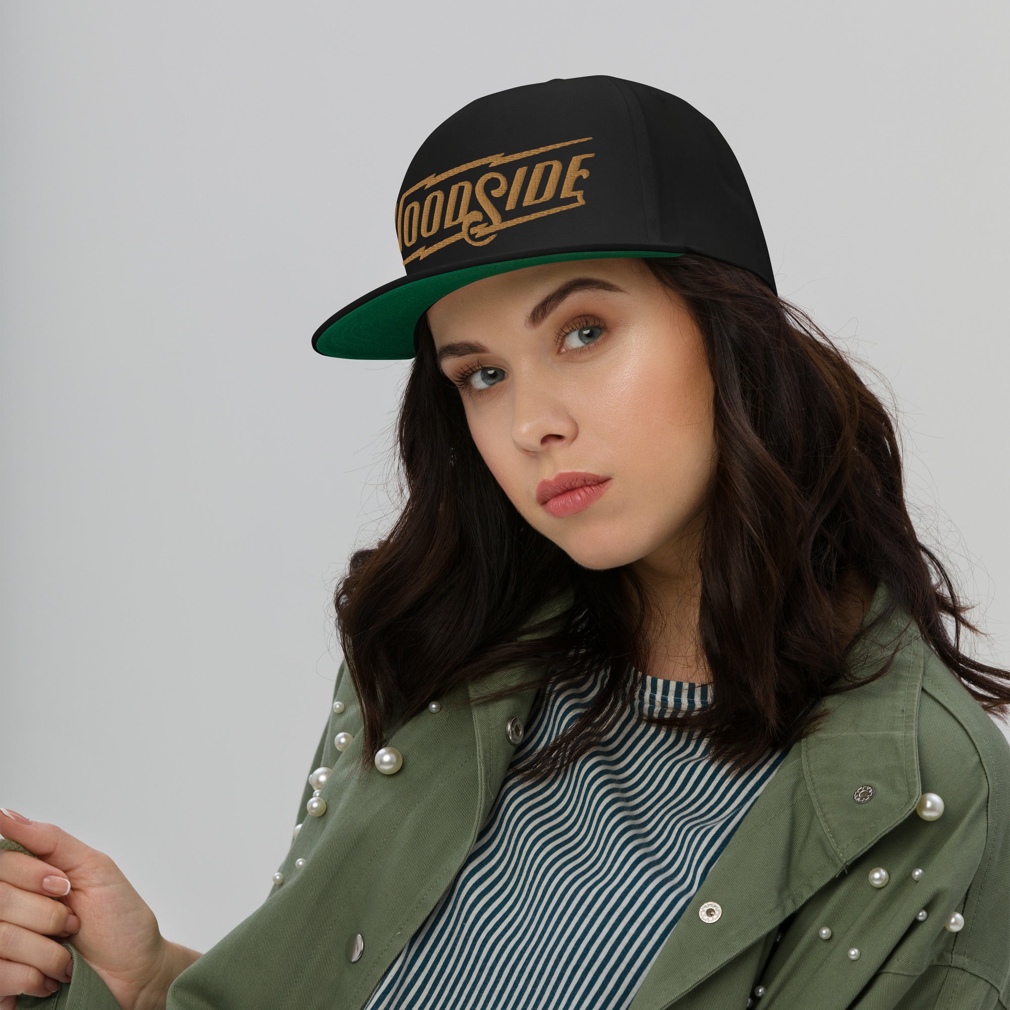 woman wearing Black Woodside Brand embroidered snapback hat with gold embroidery