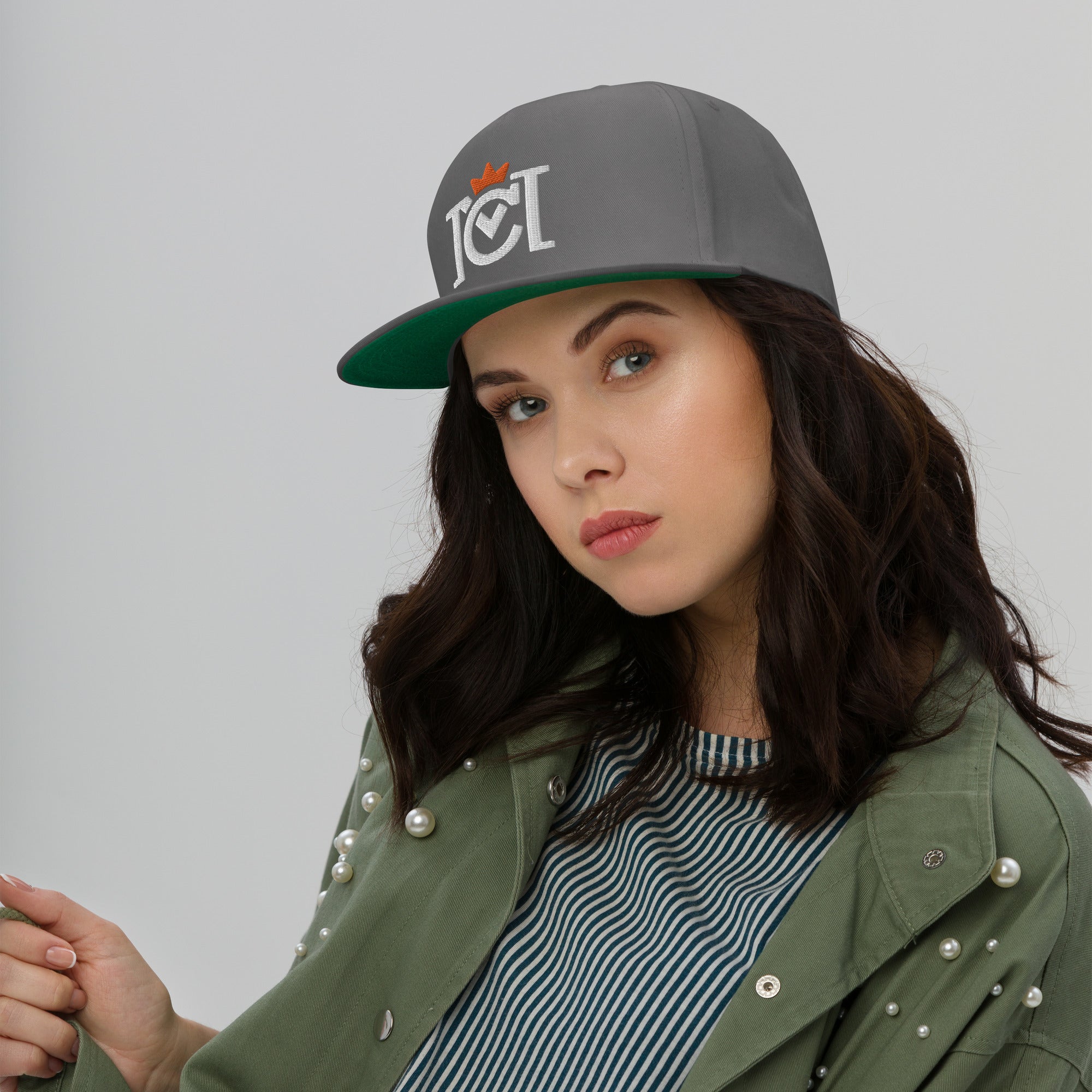 Woman wearing Trademarked Crown Moto logo embroidered in 3D puff style on front of flat bill snapback hat