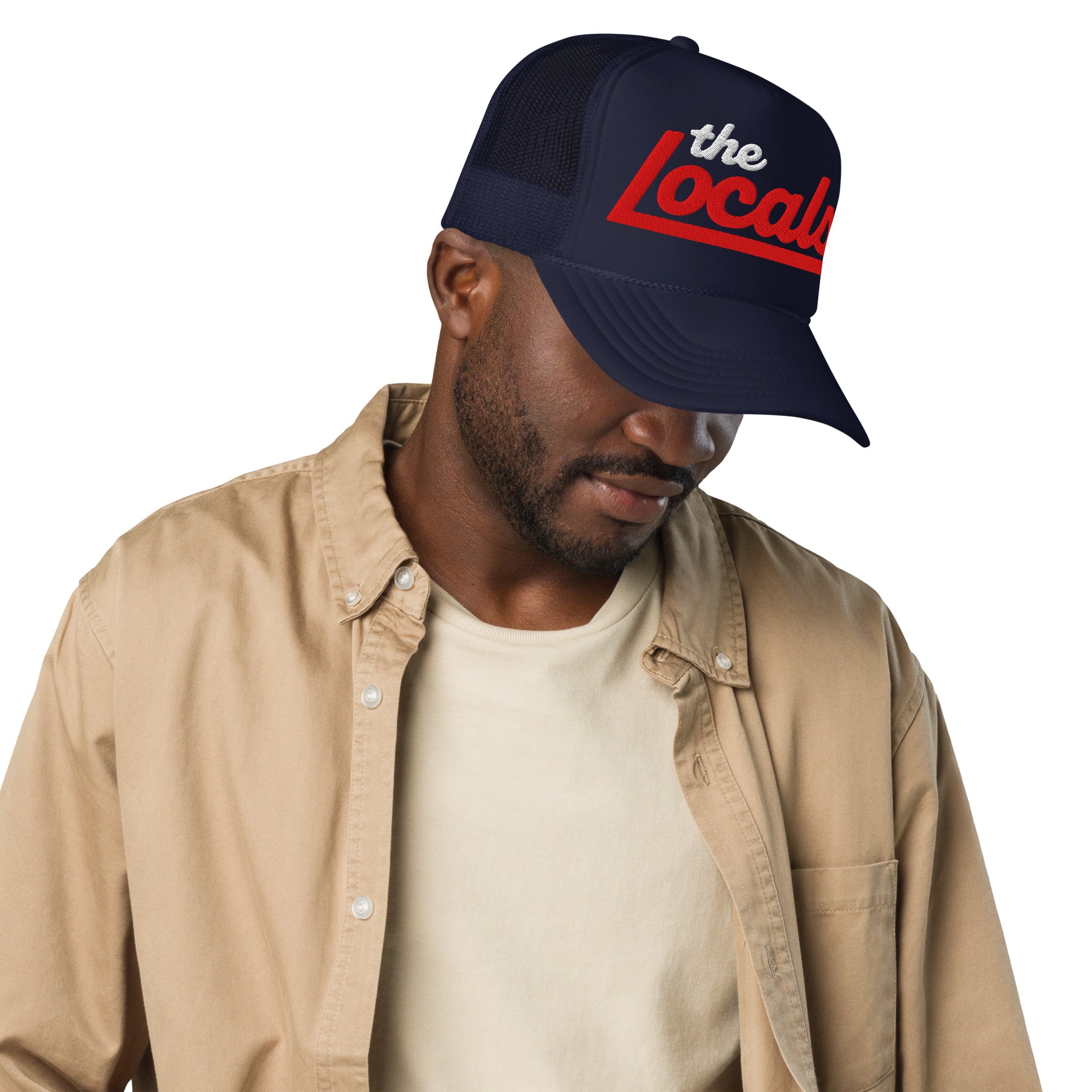 Man wearing the Locals logo design embroidered on front of foam trucker hat