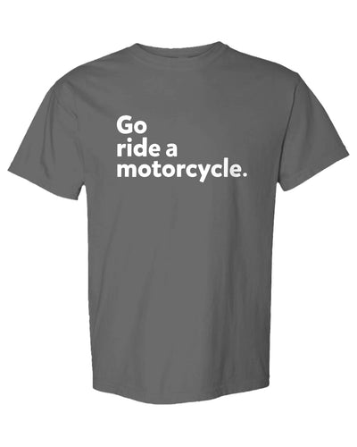 An olive green short-sleeve t-shirt with the phrase 'Go ride a motorcycle.' printed in white sans-serif text across the chest