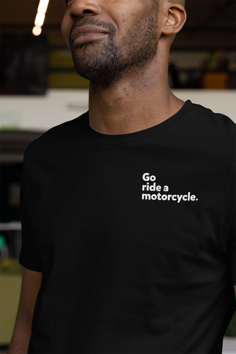 Man wearing a short sleeve t-shirt with "Go ride a motorcycle" embroidered in white on left chest