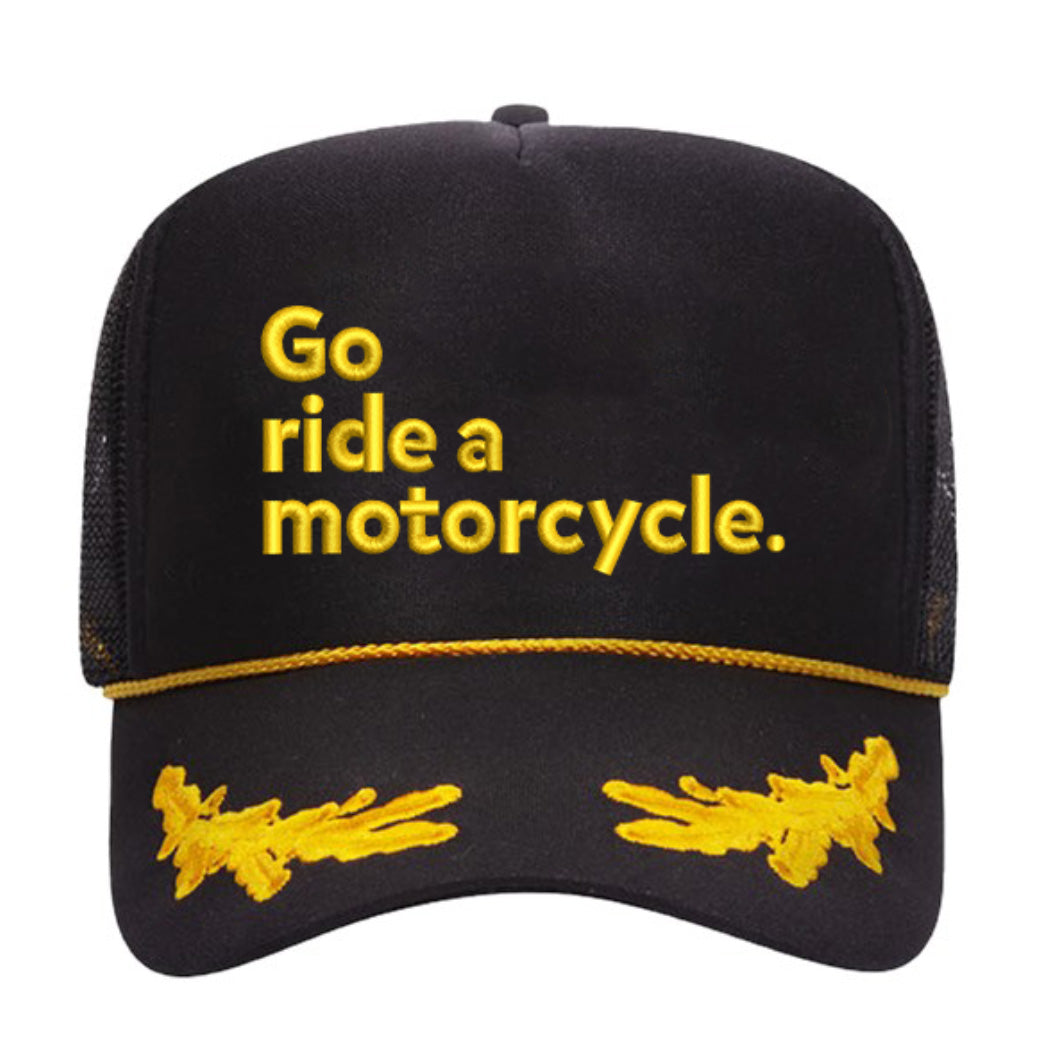 "Go ride a motorcycle" embroidered on front of black and gold snapback trucker hat with gold leaves embroidered on brim by Crown Moto