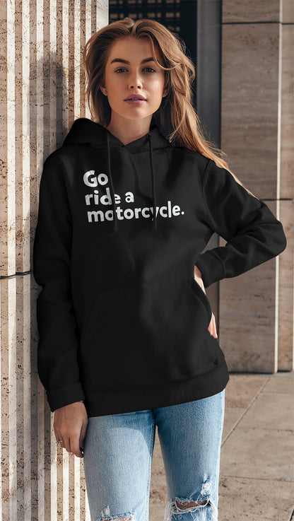 Attractive young woman wearing a black hooded sweatshirt with "Go ride a motorcycle" design printed on chest