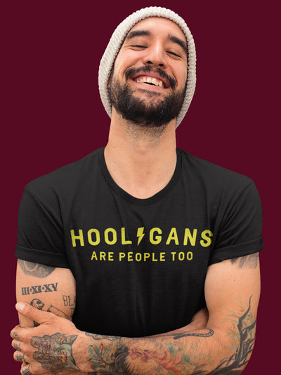 Man smiling wearing a Hooligans are people too t-shirt, design on chest of short sleeve Tultex Unisex T-Shirt, wheelies, stoppies, burnouts, street racing