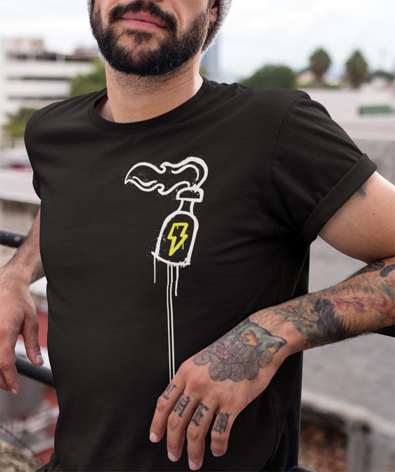 Man leaning against a rail wearing a black t-shirt with Hooligan Parade molotov cocktail logo on left chest