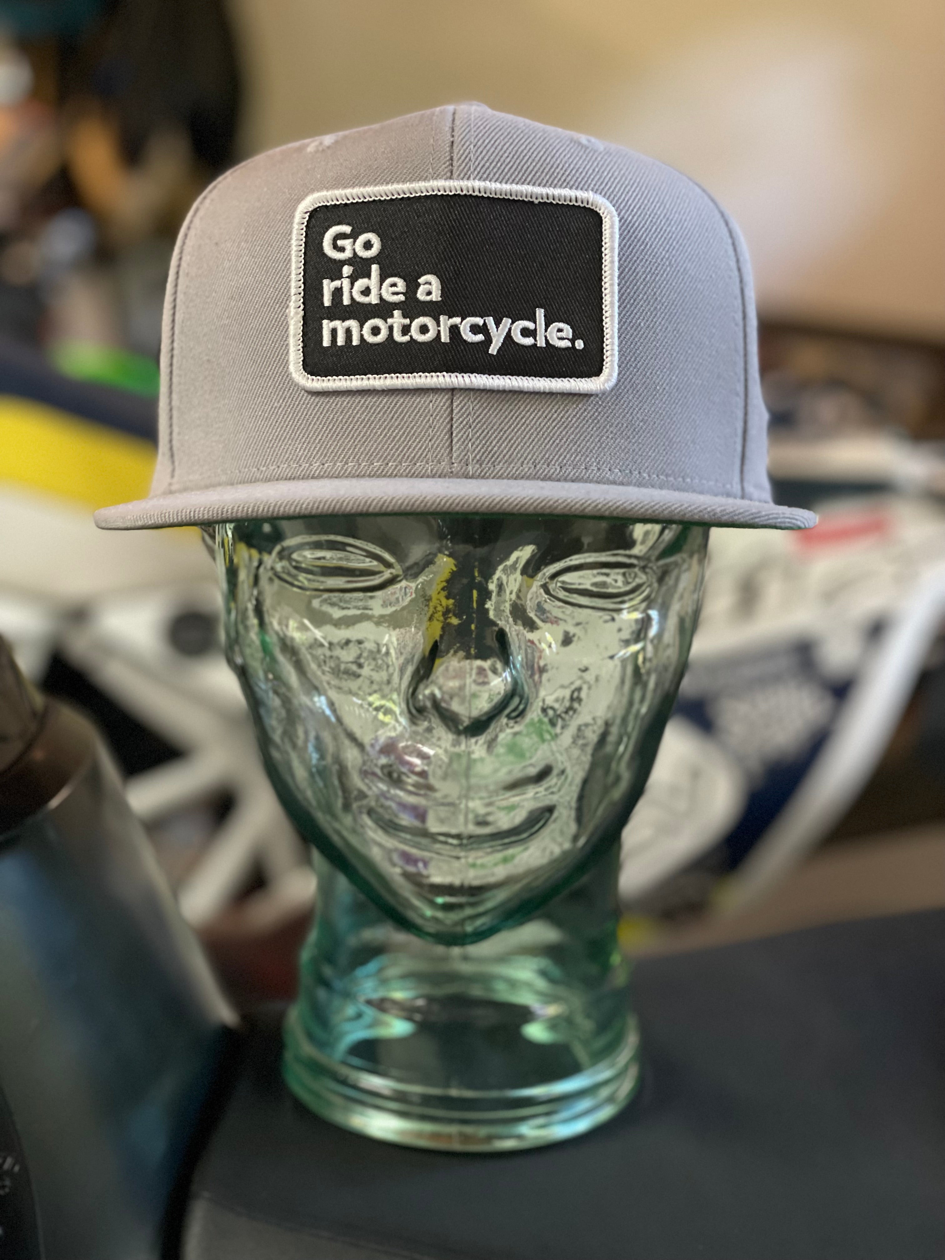 "Go ride a motorcycle" grey snapback flat brim hat from Crown Moto